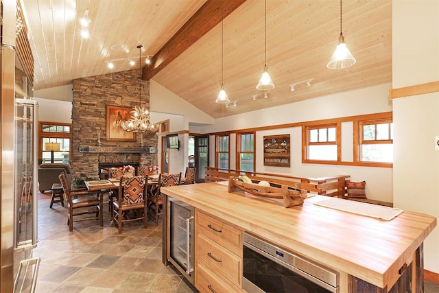 349 Harlan Creek Rd, Hamilton, MT 59840 - kitchen featuring wooden counters, wine cooler, high vaulted ceiling, a stone fireplace, and a wood ceiling with exposed beams
