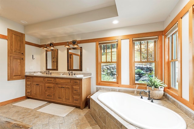 349 Harlan Creek Rd, Hamilton, MT 59840 - bathroom featuring plenty of natural light, double vanity, a bath, recessed lighting, and stone finish floors