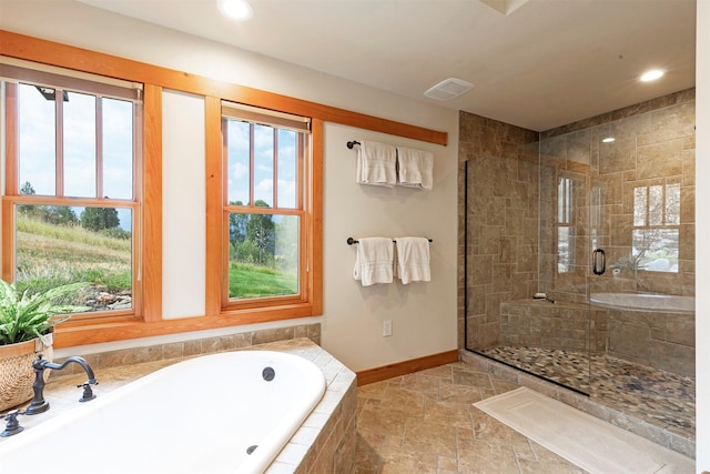 349 Harlan Creek Rd, Hamilton, MT 59840 - bathroom with a bath, a tile shower, recessed lighting, and stone finish floors