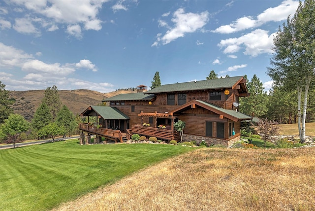 349 Harlan Creek Rd, Hamilton, MT 59840 - rear view of house featuring a lawn and a deck with mountain view
