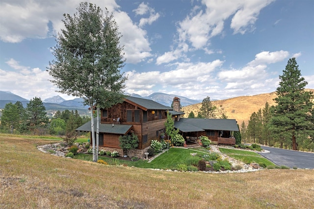 349 Harlan Creek Rd, Hamilton, MT 59840 - view of front of house with a mountain view, a front yard, and a chimney