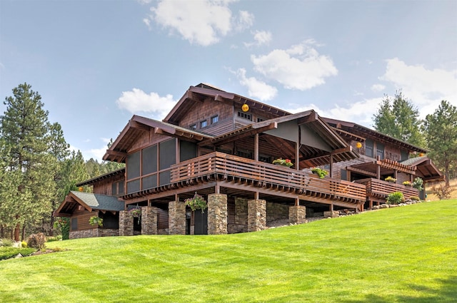 349 Harlan Creek Rd, Hamilton, MT 59840 - back of property with stone siding, a lawn, and a wooden deck