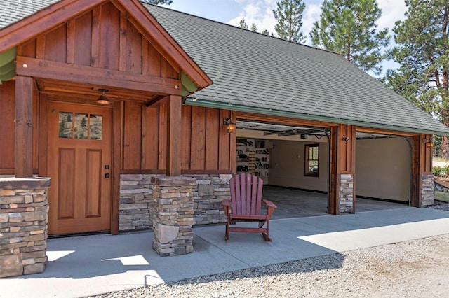 349 Harlan Creek Rd, Hamilton, MT 59840 - doorway to property featuring board and batten siding, a shingled roof, stone siding, and a garage