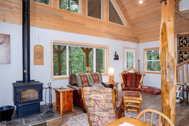 716 Kootenai River Rd, Troy, MT 59935 - living area with a wood stove, vaulted ceiling, plenty of natural light, wooden ceiling, and wood finished floors