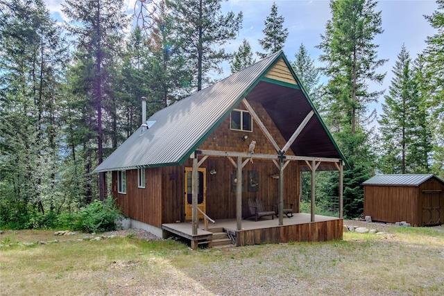 716 Kootenai River Rd, Troy, MT 59935 - view of front of home featuring a metal roof, a storage shed, and covered porch