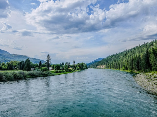 716 Kootenai River Rd, Troy, MT 59935 - water view with a forest and mountains