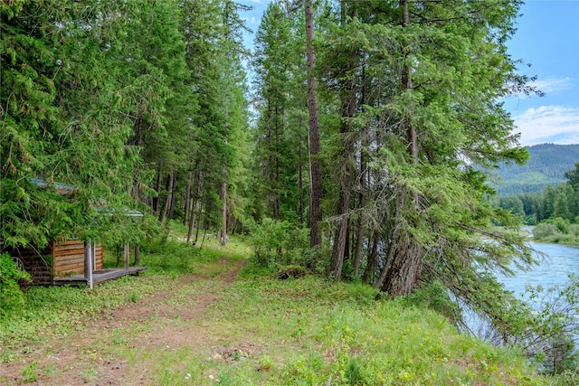 716 Kootenai River Rd, Troy, MT 59935 - view of wooded area with a water and mountain view