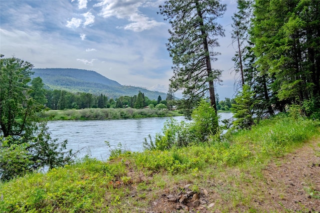 716 Kootenai River Rd, Troy, MT 59935 - water view featuring a mountainous background and a heavily wooded area