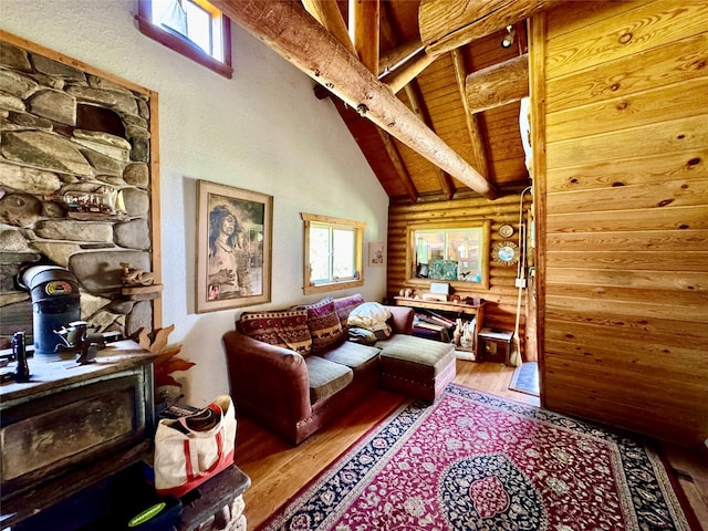 17 Twenty Peak Gulch Ln, Trout Creek, MT 59874 - living room with log walls, wood finished floors, beamed ceiling, and high vaulted ceiling