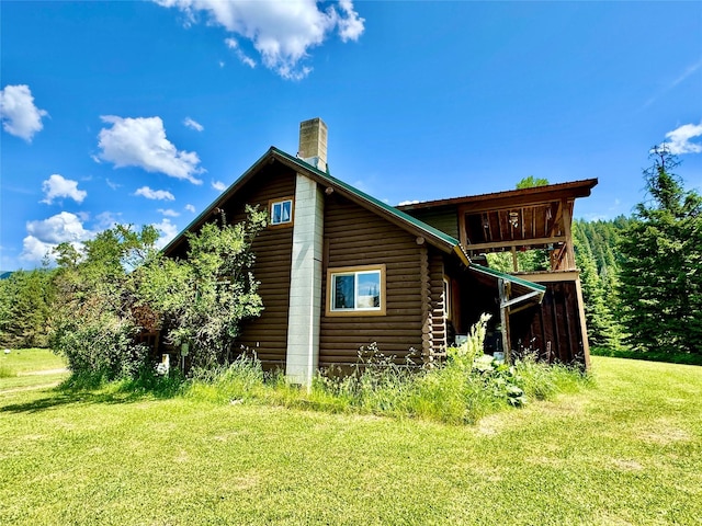 17 Twenty Peak Gulch Ln, Trout Creek, MT 59874 - back of house featuring a chimney, a yard, and log exterior