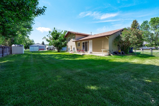 3875 Kiki Dr Unit 3875, Helena, MT 59602 - rear view of property with a fenced backyard, a patio area, and a storage shed
