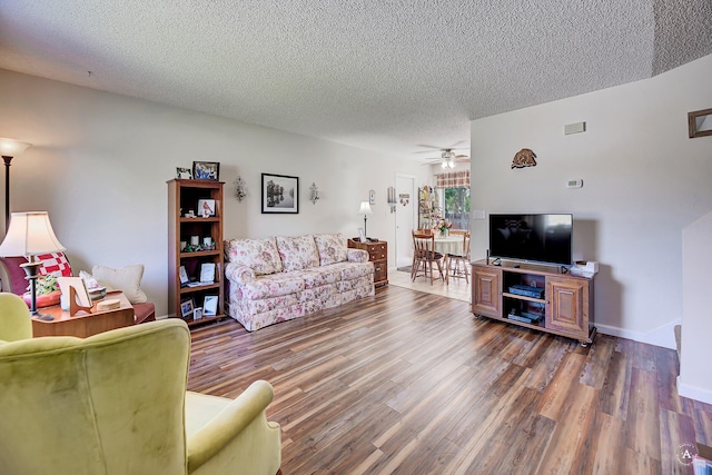 3875 Kiki Dr Unit 3875, Helena, MT 59602 - living room with a textured ceiling, wood finished floors, and a ceiling fan
