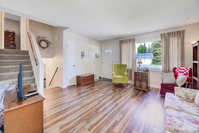 3875 Kiki Dr Unit 3875, Helena, MT 59602 - living area with a textured ceiling, light wood finished floors, and stairway