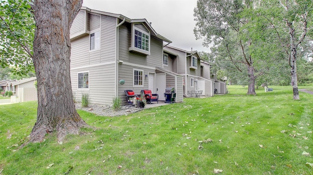 5530 Creekstone Dr Unit 6, Missoula, MT 59808 - view of property exterior featuring a lawn and a patio area
