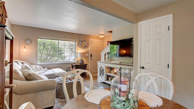 5530 Creekstone Dr Unit 6, Missoula, MT 59808 - dining area featuring wood finished floors and a textured ceiling