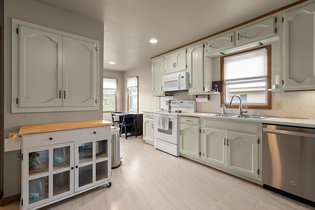 321 6th Ave W, Kalispell, MT 59901 - kitchen featuring white appliances, healthy amount of natural light, light countertops, and recessed lighting
