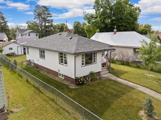 321 6th Ave W, Kalispell, MT 59901 - view of home's exterior with a shingled roof, a fenced backyard, and a chimney