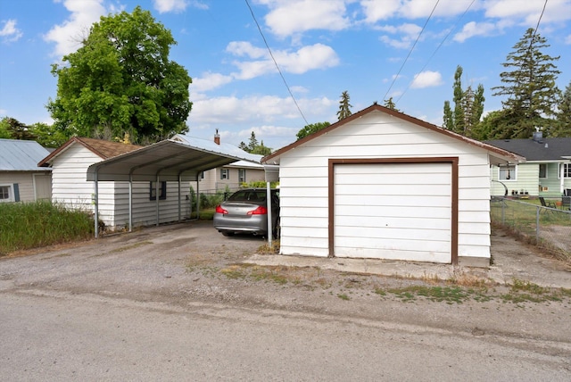 321 6th Ave W, Kalispell, MT 59901 - detached garage featuring a carport and asphalt driveway