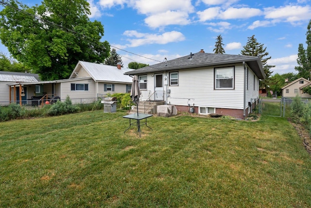 321 6th Ave W, Kalispell, MT 59901 - rear view of property featuring a fenced backyard, a gate, and a chimney