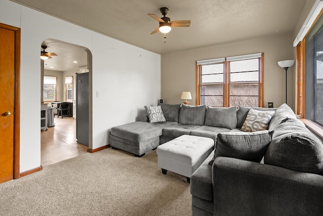 321 6th Ave W, Kalispell, MT 59901 - living room featuring ceiling fan, arched walkways, healthy amount of natural light, and light carpet