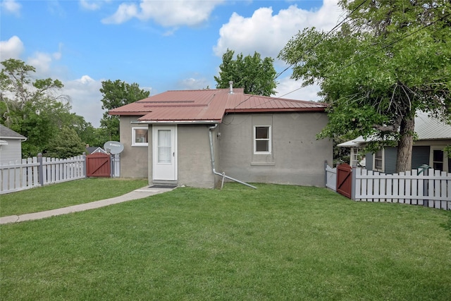 541 5th Ave, Helena, MT 59601 - back of house featuring a gate, stucco siding, a fenced backyard, and a metal roof