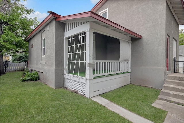 541 5th Ave, Helena, MT 59601 - view of home's exterior with stucco siding and a sunroom
