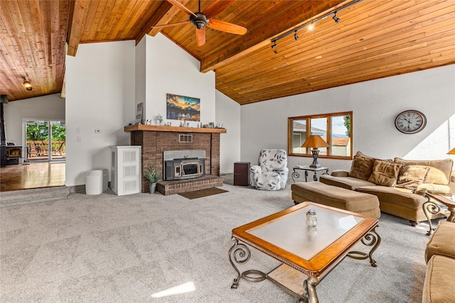 4291 Williams Ln, Stevensville, MT 59870 - carpeted living room with a wooden ceiling with exposed beams, a wood stove, track lighting, a ceiling fan, and high vaulted ceiling