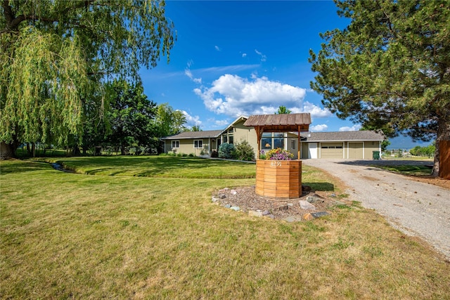 4291 Williams Ln, Stevensville, MT 59870 - ranch-style house with dirt driveway, a front yard, and an attached garage