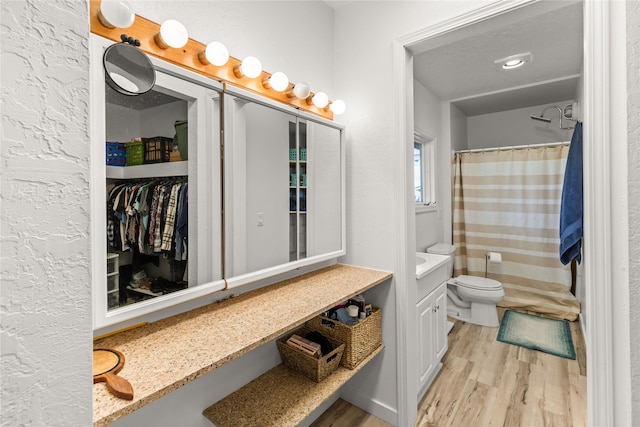 4291 Williams Ln, Stevensville, MT 59870 - bathroom featuring wood finished floors, vanity, a shower with shower curtain, and a spacious closet