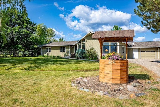 4291 Williams Ln, Stevensville, MT 59870 - view of front of property featuring a front lawn, a garage, and driveway