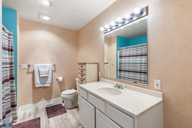 4291 Williams Ln, Stevensville, MT 59870 - full bathroom with a textured wall, vanity, wood finished floors, and a shower with shower curtain