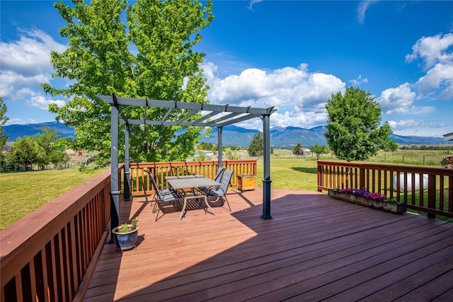 4291 Williams Ln, Stevensville, MT 59870 - wooden terrace featuring a mountain view, outdoor dining area, a yard, and a pergola