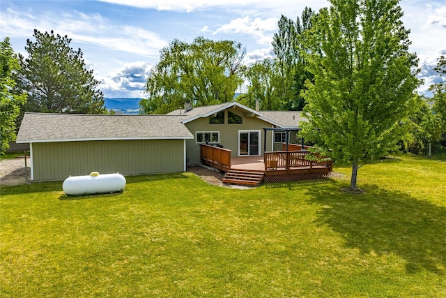 4291 Williams Ln, Stevensville, MT 59870 - rear view of property featuring a wooden deck, a yard, and roof with shingles