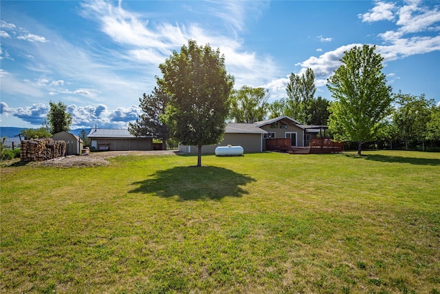 4291 Williams Ln, Stevensville, MT 59870 - view of grassy yard featuring a deck and a storage unit