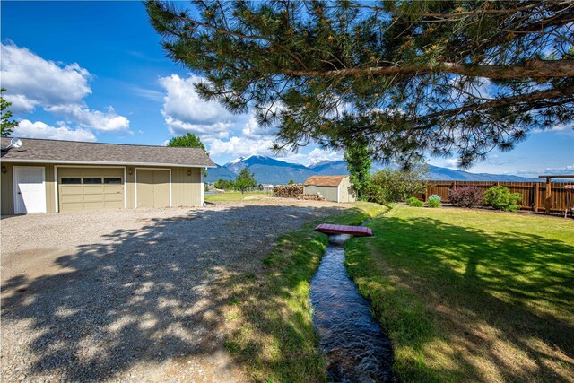 4291 Williams Ln, Stevensville, MT 59870 - view of yard with a storage shed, a mountain view, and a garage