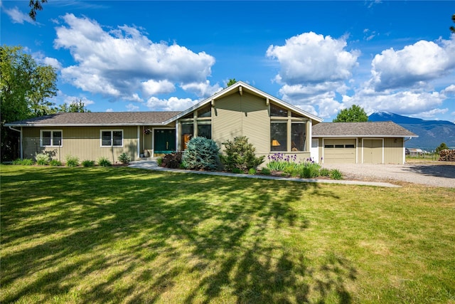 4291 Williams Ln, Stevensville, MT 59870 - view of front of house featuring an attached garage, driveway, a front yard, and a mountain view