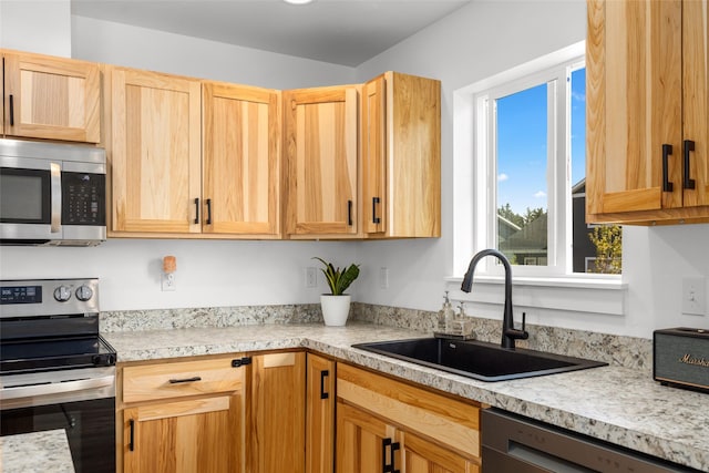 522 Pheasant Ln, Kalispell, MT 59901 - kitchen featuring appliances with stainless steel finishes, light countertops, and light brown cabinetry