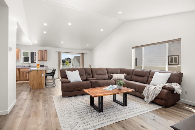 522 Pheasant Ln, Kalispell, MT 59901 - living area featuring vaulted ceiling, light wood finished floors, and recessed lighting