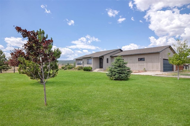 8340 Green Meadow Dr, Helena, MT 59602 - rear view of house with a lawn and an attached garage