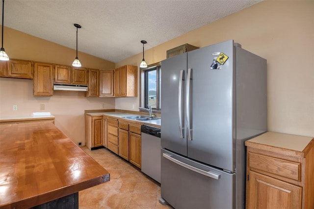 8340 Green Meadow Dr, Helena, MT 59602 - kitchen with freestanding refrigerator, dishwasher, under cabinet range hood, hanging light fixtures, and vaulted ceiling