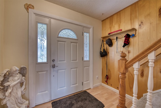 238 Hillcrest Dr, Hamilton, MT 59840 - entryway featuring a textured ceiling, plenty of natural light, light wood finished floors, and stairs