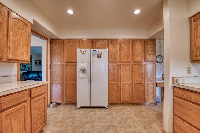 238 Hillcrest Dr, Hamilton, MT 59840 - kitchen with white fridge with ice dispenser, light countertops, brown cabinets, and recessed lighting