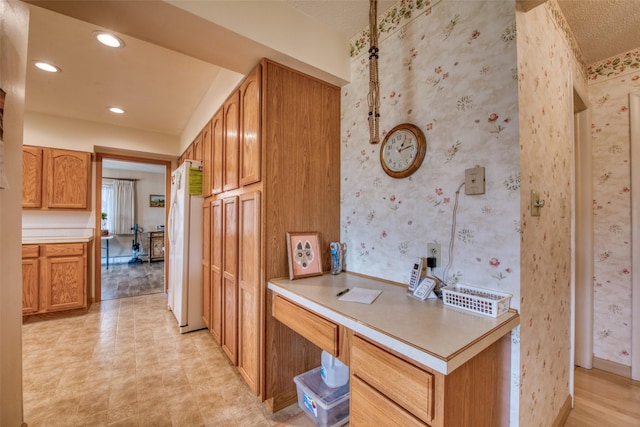238 Hillcrest Dr, Hamilton, MT 59840 - kitchen featuring freestanding refrigerator, a desk, light countertops, recessed lighting, and brown cabinets