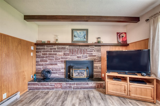 238 Hillcrest Dr, Hamilton, MT 59840 - living room with baseboard heating, beam ceiling, wood walls, wood finished floors, and a wainscoted wall