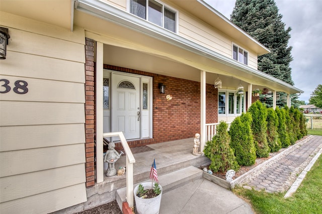 238 Hillcrest Dr, Hamilton, MT 59840 - view of exterior entry with a porch and brick siding