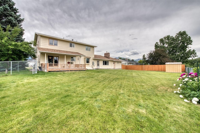 238 Hillcrest Dr, Hamilton, MT 59840 - back of house featuring a fenced backyard, a shed, a deck, and a chimney