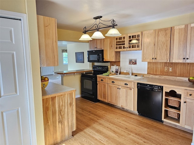1109 W Main St, Hamilton, MT 59840 - kitchen featuring black appliances, light brown cabinets, light wood-type flooring, glass insert cabinets, and backsplash