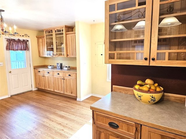 1109 W Main St, Hamilton, MT 59840 - kitchen with light wood-style floors, glass insert cabinets, electric panel, a chandelier, and decorative light fixtures