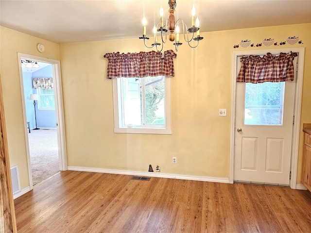 1109 W Main St, Hamilton, MT 59840 - unfurnished dining area featuring light wood finished floors and a chandelier