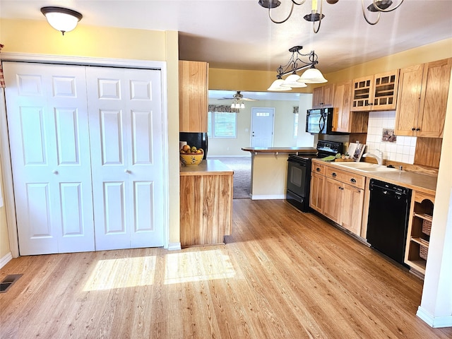 1109 W Main St, Hamilton, MT 59840 - kitchen featuring black appliances, light wood-style flooring, ceiling fan, and glass insert cabinets
